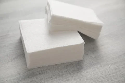 Stack of napkins on the white table. Stock Photos