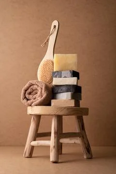 A stack of natural handmade soap bars with a wooden back brush and rolled tow Stock Photos