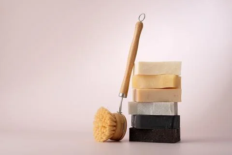 Stack of natural organic soap bars and cleaning brush. Cleaning products conc Stock Photos