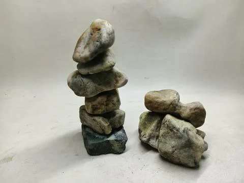Stack of natural river stones and weathered rocks on a white background Stock Photos