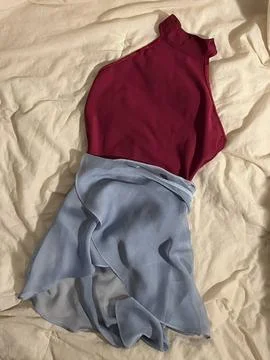 Stack of neatly folded clothes in various colors and fabrics, showing layer.. Stock Photos