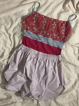 Stack of neatly folded clothes in various colors and fabrics, showing layer.. Stock Photos