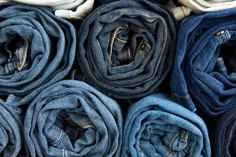 A stack of neatly rolled jeans Stock-Fotos