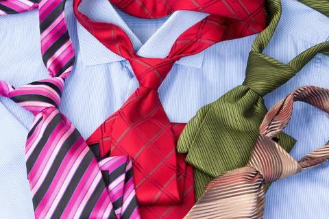 Stack of neckties on blue shirt Stock Photos