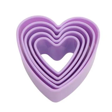 Stack of nested heart shaped cookie cutters isolated on white background. P.. 스톡 사진
