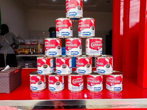 Stack of Nestle Carnation sweetened condensed milk cans Stock Photos