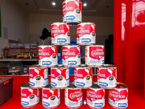 Stack of Nestle Carnation sweetened condensed milk cans Stock Photos
