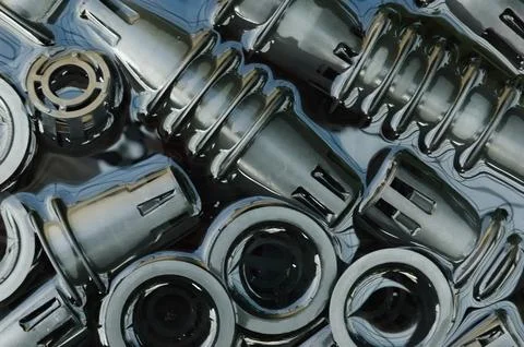 Stack of netpots in water soaking during washing process in storage basket... Stock Photos