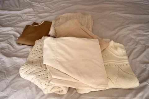 Stack of Neutral Knit Sweaters and Clothing Fabrics Stock Photos