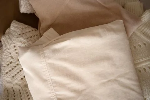 Stack of Neutral Knit Sweaters and Clothing Fabrics Stock Photos