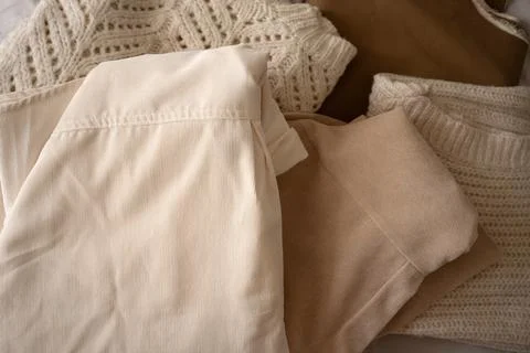 Stack of Neutral Knit Sweaters and Clothing Fabrics Foto stock