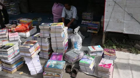 Stack of new and used books on the sidewalk for sale Stock Footage 40741030