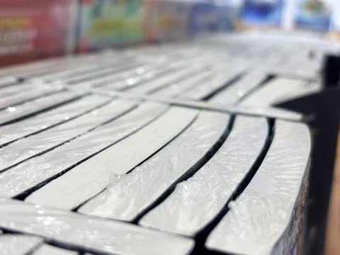 Stack of New Books Wrapped in Plastic on Bookstore Shelf Stock Photos