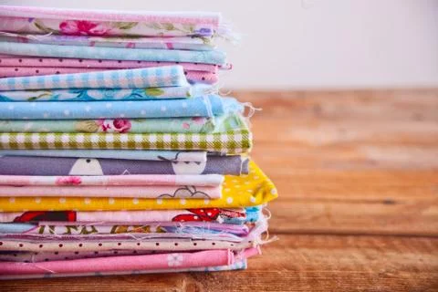 Stack of of new fabrics in different colors cloth on the wooden table Stock Photos