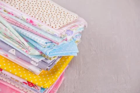 Stack of of new fabrics in different colors cloth on the table Stock-Fotos