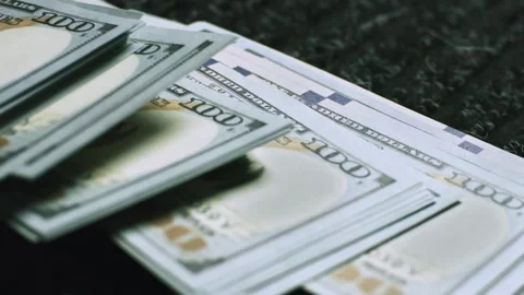 Stack of new hundred dollar banknotes being placed on dark surface as sign .. Stock Footage 337601829