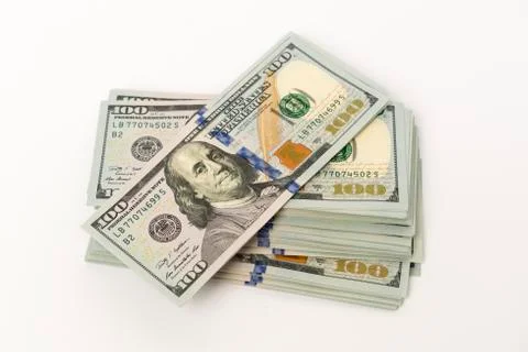 Stack of new hundred dollar banknotes on white surface Foto stock
