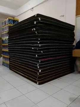 A Stack of New Mattresses Ready for Delivery in a Warehouse Stock Photos