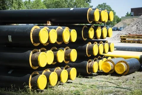 A stack of new pipes for district heating at a construction site in Duesseldorf Foto stock