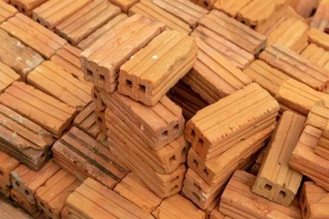 Stack of new rectangular bricks red with two holes background construction Stock Photos