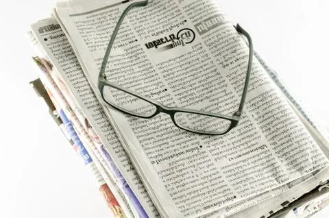 Stack of newspaper with glasses Stock Photos