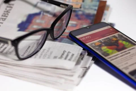 Stack of newspapers and glasses in black and white. Stock Photos