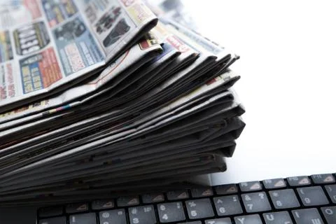 Stack of newspapers and keyboard close-up 写真素材