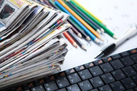 Stack of newspapers and keyboard close-up Foto stock