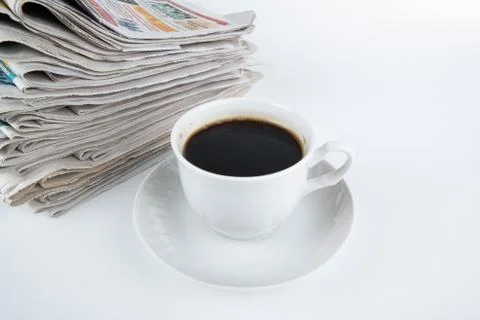Stack of newspapers with cup of coffee close-up Stock Photos