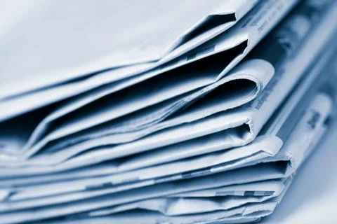 Stack of newspapers toned blue Stock Photos
