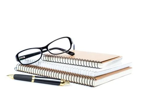Stack notebook, pen and glasses. Stock Photos