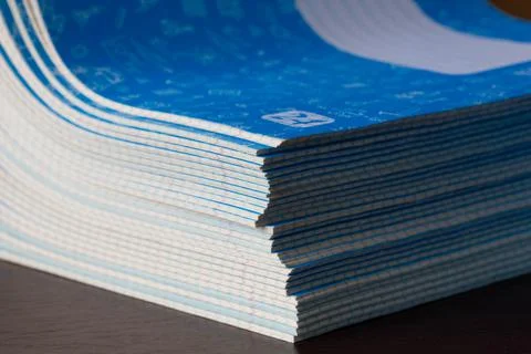 Stack of Notebooks. A pack of blue school notebooks on the brown table Stock Photos