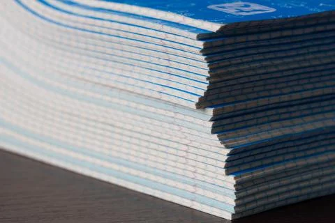 Stack of Notebooks. A pack of blue school notebooks on the brown table Stock Photos
