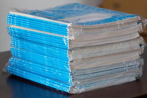 Stack of Notebooks. A pack of blue school notebooks in cellophane Stock Photos