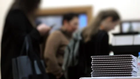 Stack of notebooks on table during business conference registration. Видео 320885090