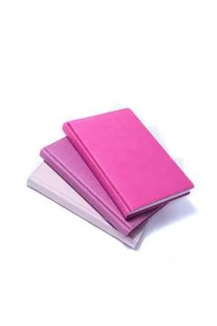A stack of notebooks on a white background Photos
