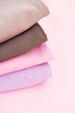 Stack of nude pink clothes on pink background Stock Photos