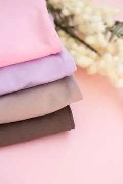 Stack of nude pink clothes on pink background Stock Photos