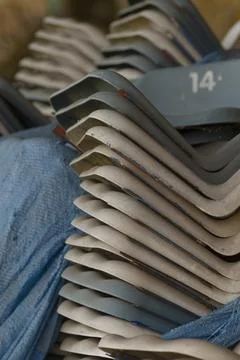 Stack of numbered metal roofing tiles with worn paint Stock Photos