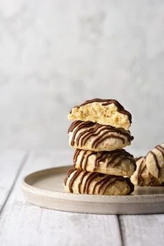 Stack of nut cookies with ground almonds, with chocolate icing stripes, on a Stock Photos