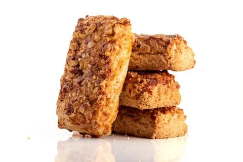 Stack oatmeal cookies cinnamon with nuts isolated on white table Stock Photos