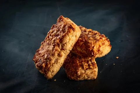 Stack oatmeal cookies cinnamon with nuts isolated on dark table Foto stock