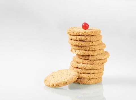 Stack of oatmeal cookies with cranberries on top on light glass background Stock-Fotos
