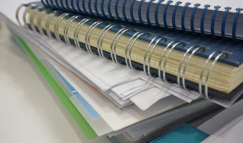 Stack of office document and ring binder book on desk Stock Photos