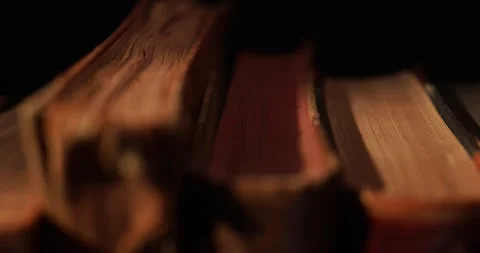 Stack of old antique books in a ray of light Stock Footage 311706825