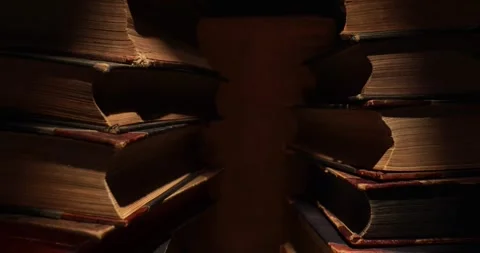 Stack of old antique books in a ray of light. Video stock 311706847