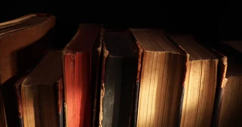 Stack of old antique books in a ray of light. Stock Footage 311706851