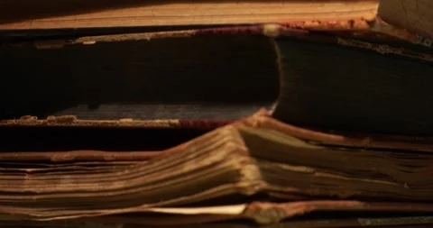 Stack of old antique books in a ray of light. Video stock 311707051
