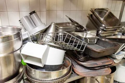 Stack of old baking trays in an industrial kitchen Stock Photos
