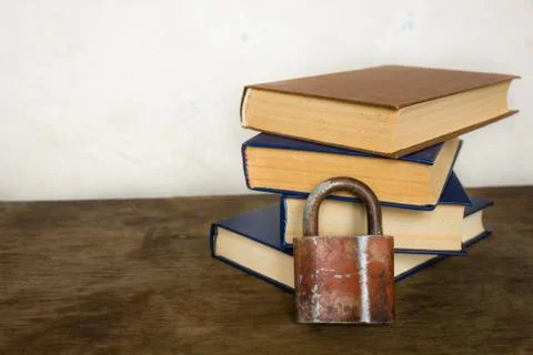 Stack of old big books and lock 스톡 사진